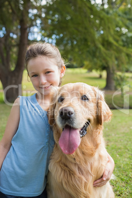 Little girl with her dog in the park