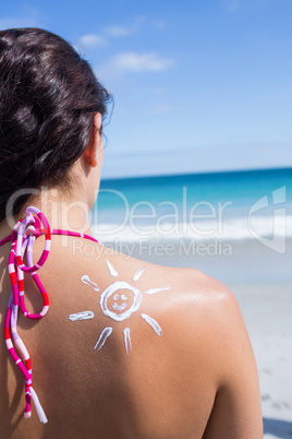 Brunette with sun tan lotion on her shoulder
