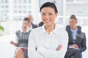 Business people looking at camera with arms crossed