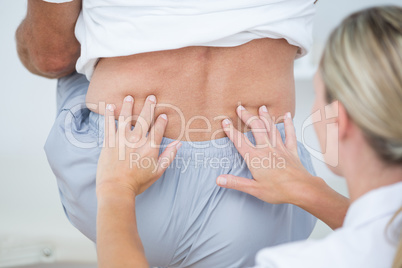 Doctor examining her patient back