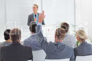Pretty businesswoman talking in microphone during conference