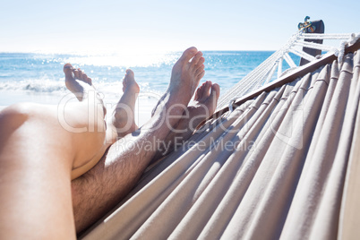 Happy couple napping together in the hammock