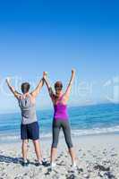 Happy couple raising their hands