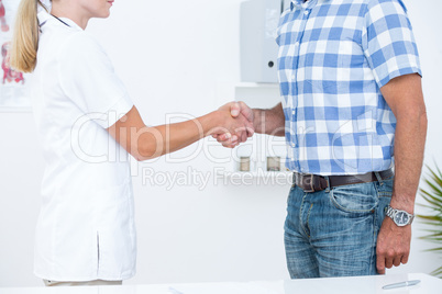 Patient shaking hands with doctor