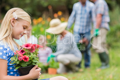 Young girl sitting with flower pot