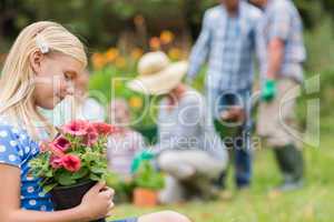 Young girl sitting with flower pot