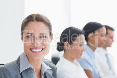 Smiling business people looking at camera