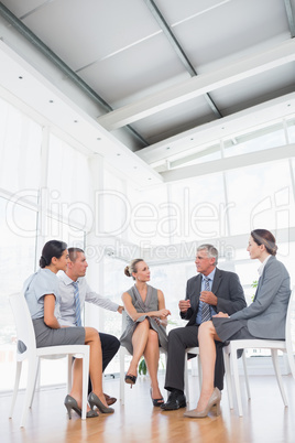 Business team sitting in circle and discussing