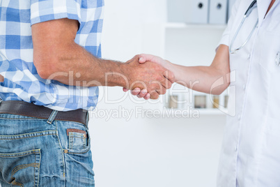 Patient shaking hands with doctor