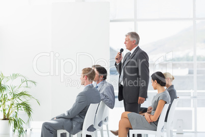 Businessman talking in microphone during conference