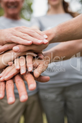 Happy volunteer family putting their hands together