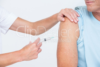 Doctor doing an injection to her patient