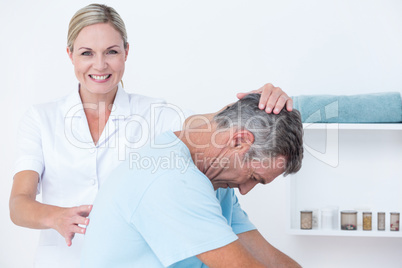 Doctor stretching a man back