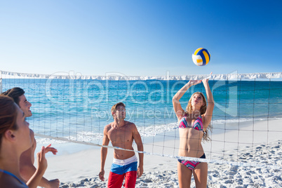 Group of friends playing volleyball