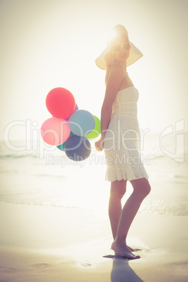 Beautiful blonde holding balloons