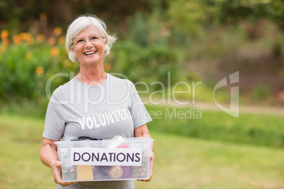 Happy grandmother holding donation box