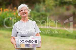Happy grandmother holding donation box