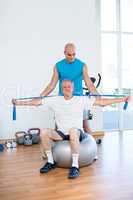 Trainer examining his patient back