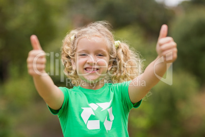 Happy little girl in green with thumbs up