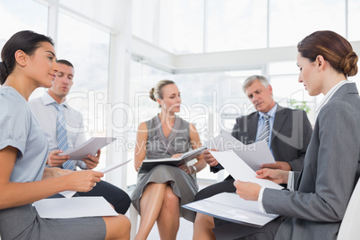 Business team sitting in circle and discussing