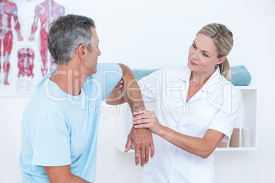 Doctor stretching a man arm