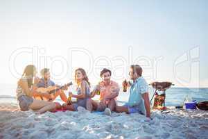 Happy hipsters relaxing and playing guitar