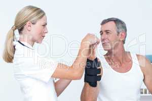 Doctor examining a man wrist
