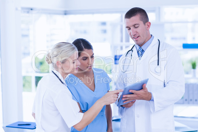 Doctors looking together at tablet