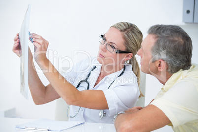 Doctor showing X rays to her patient