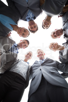 Smiling business team standing in circle