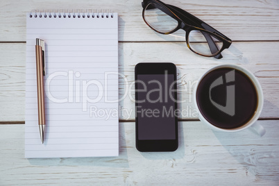 Overhead shot of notepad and smartphone