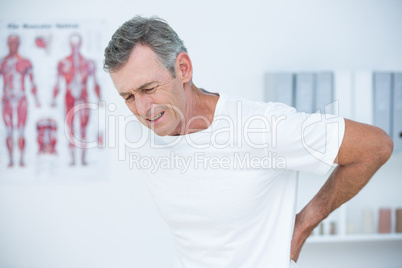 Suffering patient touching his back
