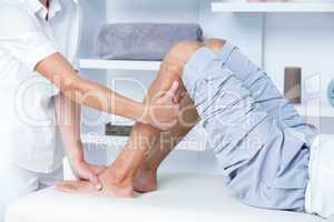 Physiotherapist doing calf massage to her patient