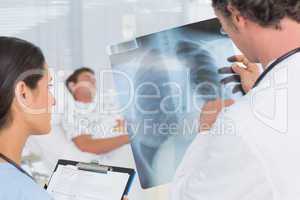 Doctors checking patients xray