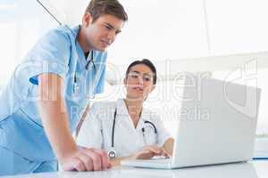 Doctors working on laptop computer