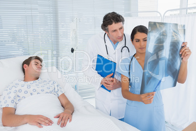 Doctors examining patients xray