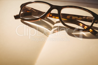 Empty notepad with reading glasses