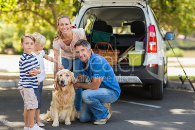 Happy family with their dog in the park