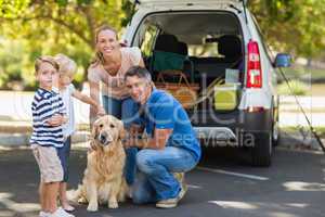 Happy family with their dog in the park