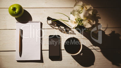 Overhead shot of notepad and smartphone