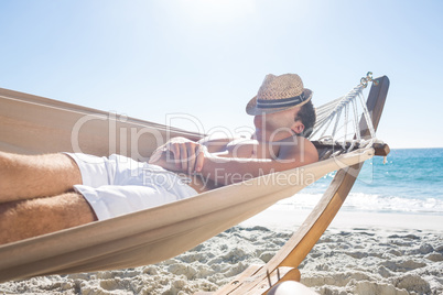 Handsome man resting in the hammock