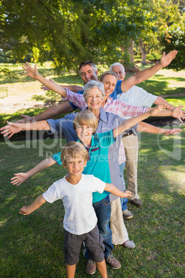 Happy family with arms outstretched in the park