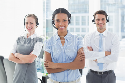 Business people with headsets smiling at camera