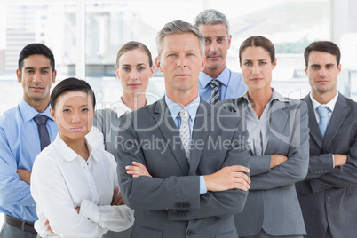 Unhappy business people looking at camera with arms crossed