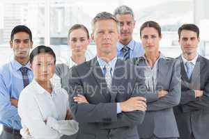 Unhappy business people looking at camera with arms crossed