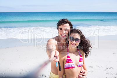 Happy couple taking selfie with selfie stick