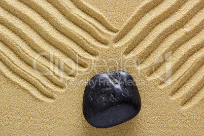 Zen stone in the sand