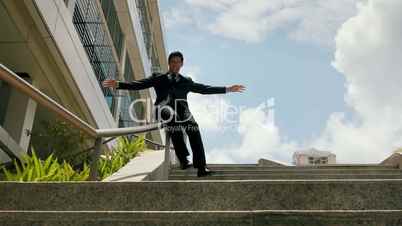 Chinese Businessman Going Downstairs Sliding On Rail For Joy