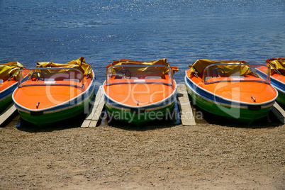 Pedal boats side by side on the shores