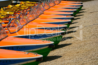 Pedal boats in a row at the shore